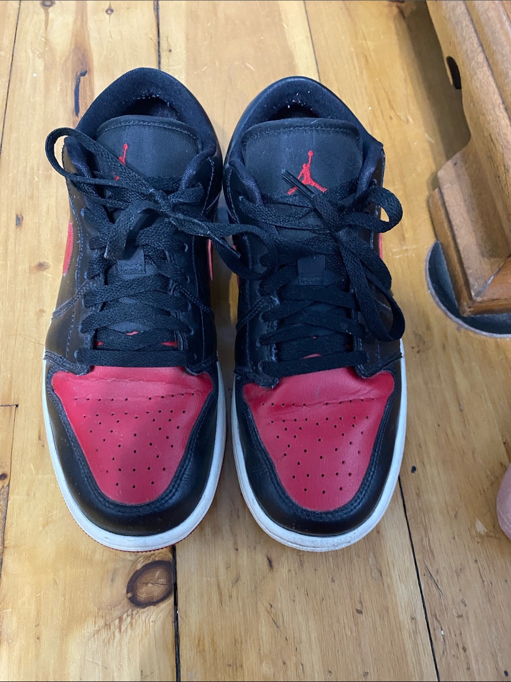 Womens Black and Red Low-Top Jordans some wear but good condition  size 9.5